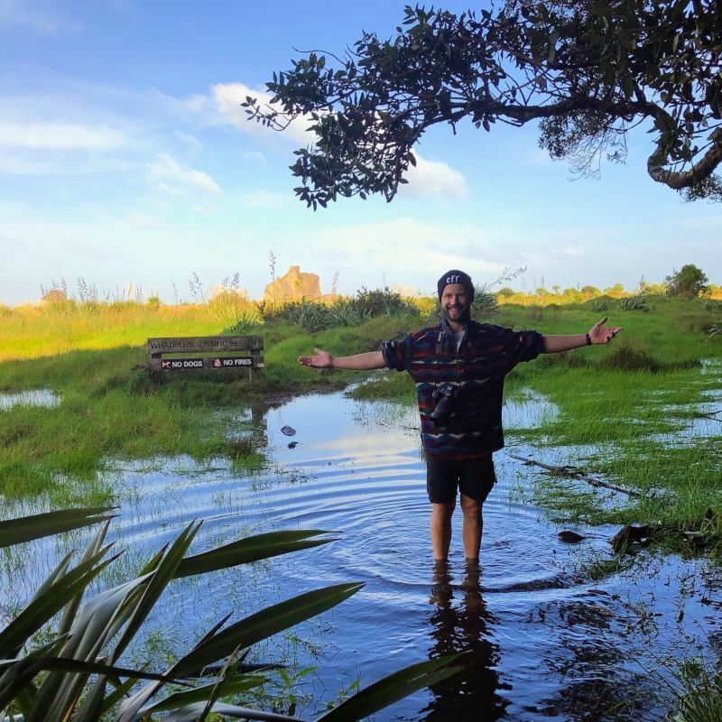 Ieuan standing on a flooded footpath at Whatipu scientific reserve